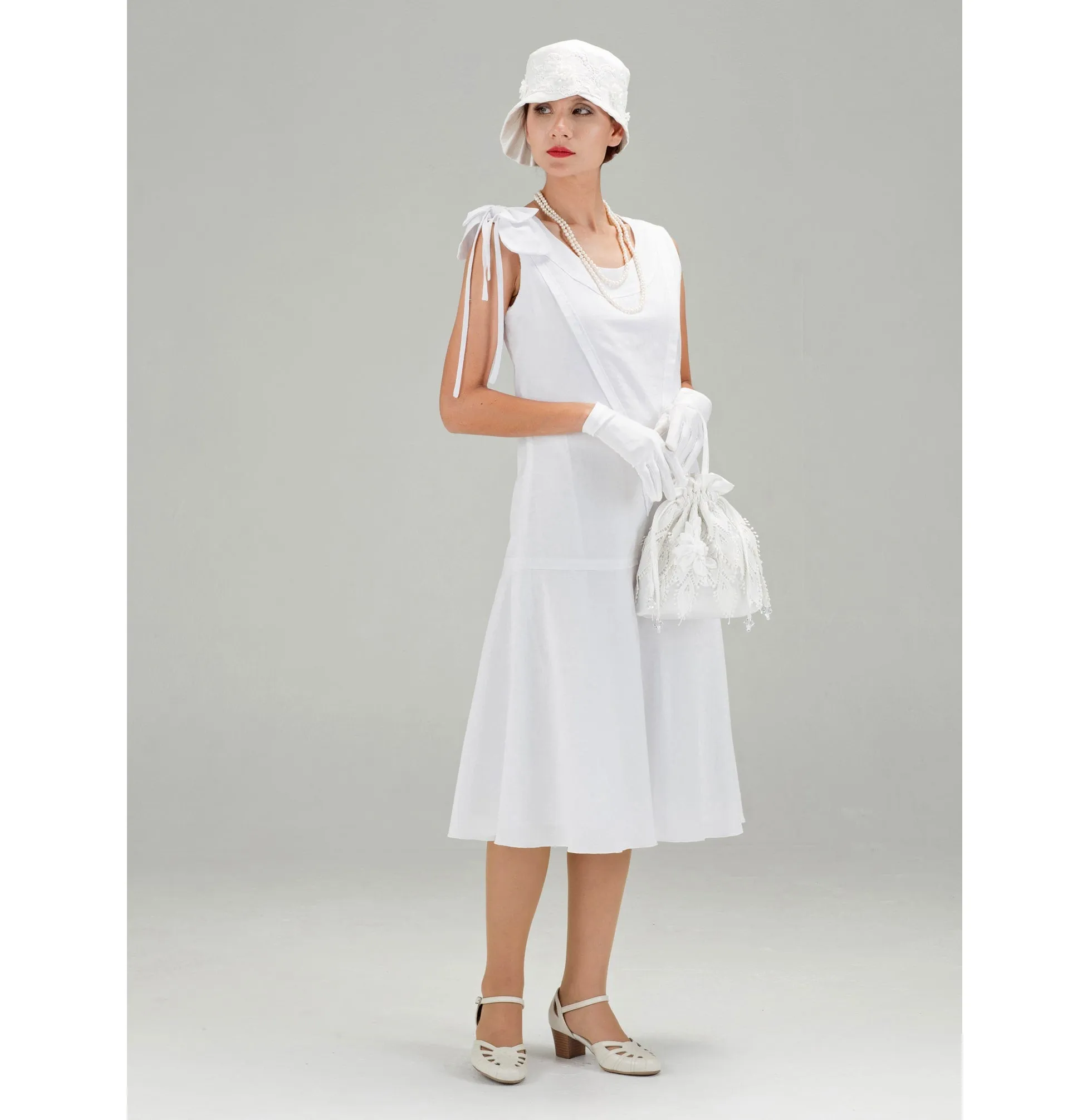 1920s high tea dress in white cotton with bow on shoulder