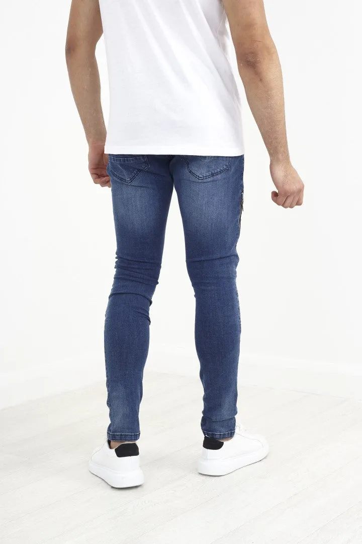 MID BLUE BIKER STYLE ZIP DETAIL RIPPED DENIM JEANS
